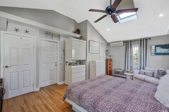 a spacious bedroom with a bed and a chandelier