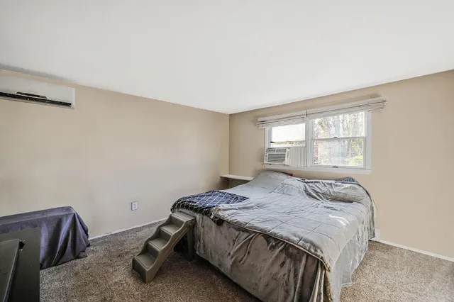 a bedroom with a bed and window