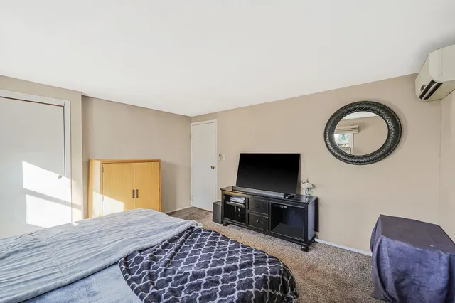 a bedroom with a bed and a television