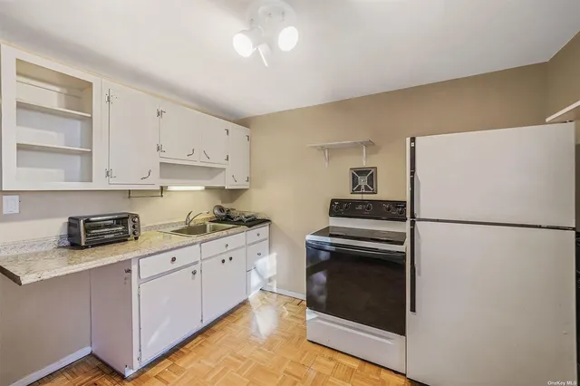 a kitchen with stainless steel appliances a refrigerator sink and cabinets