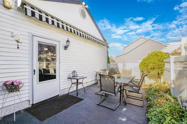 a view of a patio with table and chairs and potted plants