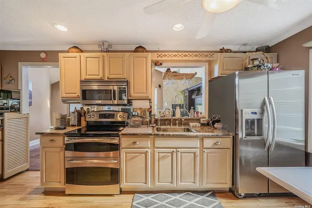 a kitchen with kitchen island granite countertop a stove cabinets and refrigerator