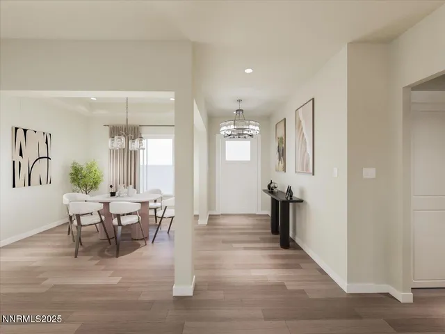 a living room with furniture a wooden floor and a chandelier