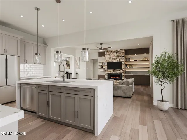 a large kitchen with stainless steel appliances kitchen island granite countertop a stove a sink and a refrigerator