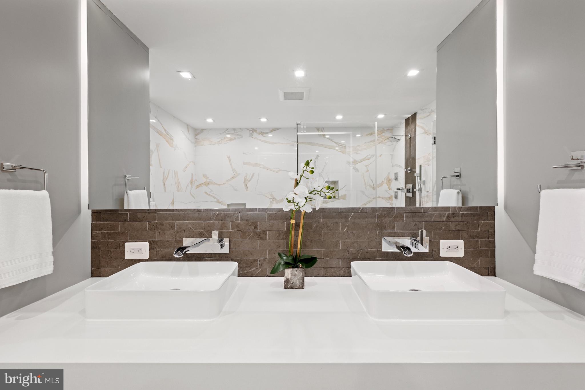 3728 R Street Northwest Washington, DC 20007 - Photo 14 of 34 a bathroom with a sink a large mirror and vanity