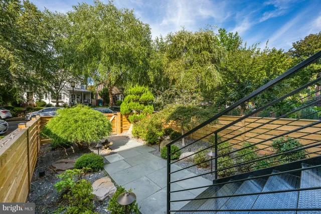 a kitchen with stainless steel appliances kitchen island granite countertop a stove and a wooden floors