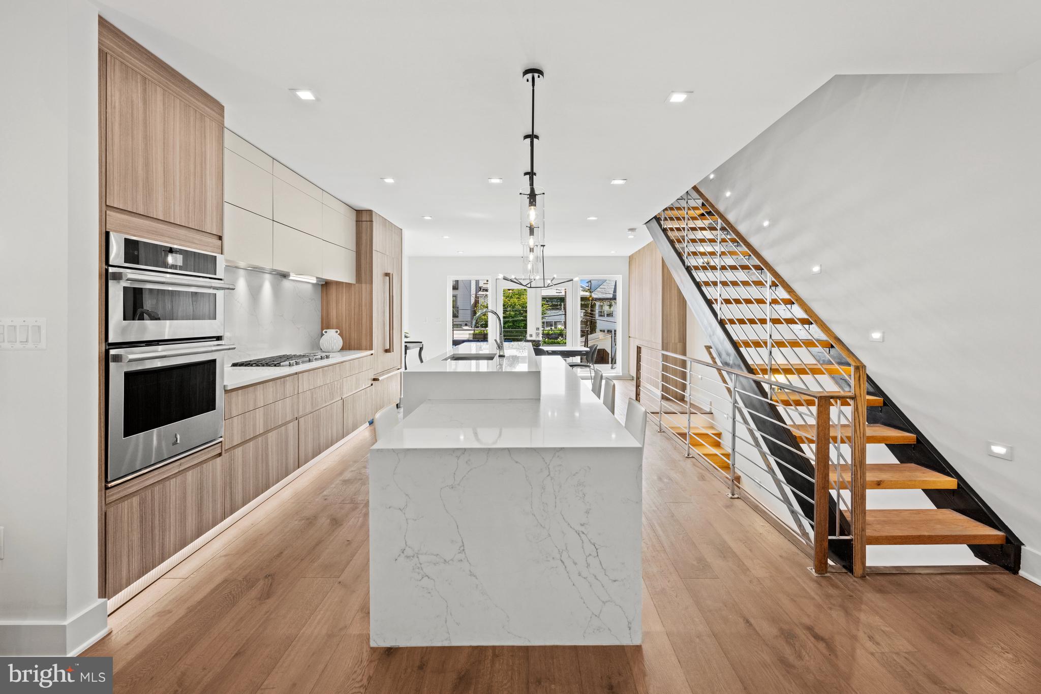 3728 R Street Northwest Washington, DC 20007 - Photo 32 of 34 a kitchen with stainless steel appliances kitchen island granite countertop a stove and a wooden floors