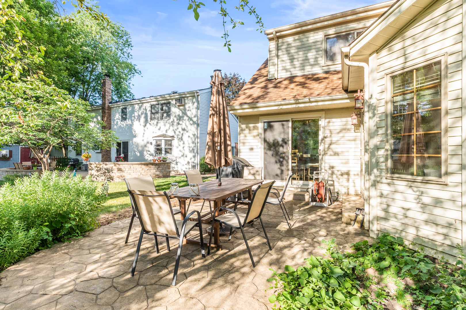 417 South River Road Naperville, IL 60540 - Photo 24 of 26 a view of a dining room with a table and chairs and potted plants