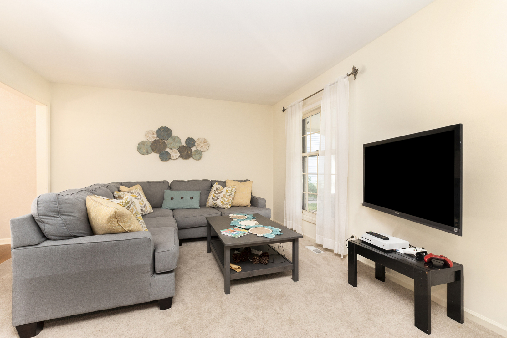417 South River Road Naperville, IL 60540 - Photo 9 of 26 a living room with furniture and a flat screen tv