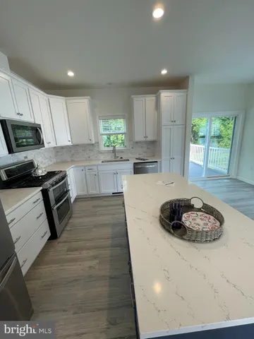 a kitchen with a stove a refrigerator and a sink