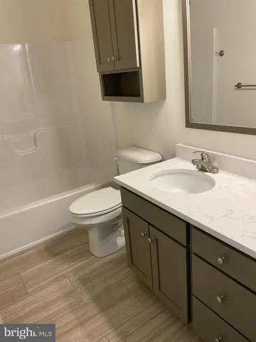 a bathroom with a sink toilet and mirror