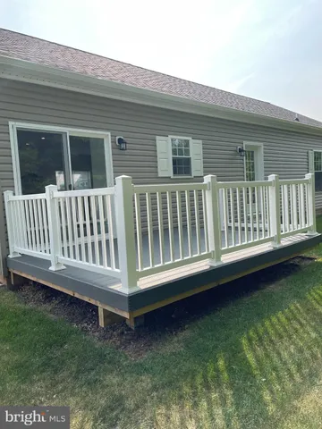 a view of a deck in the backyard