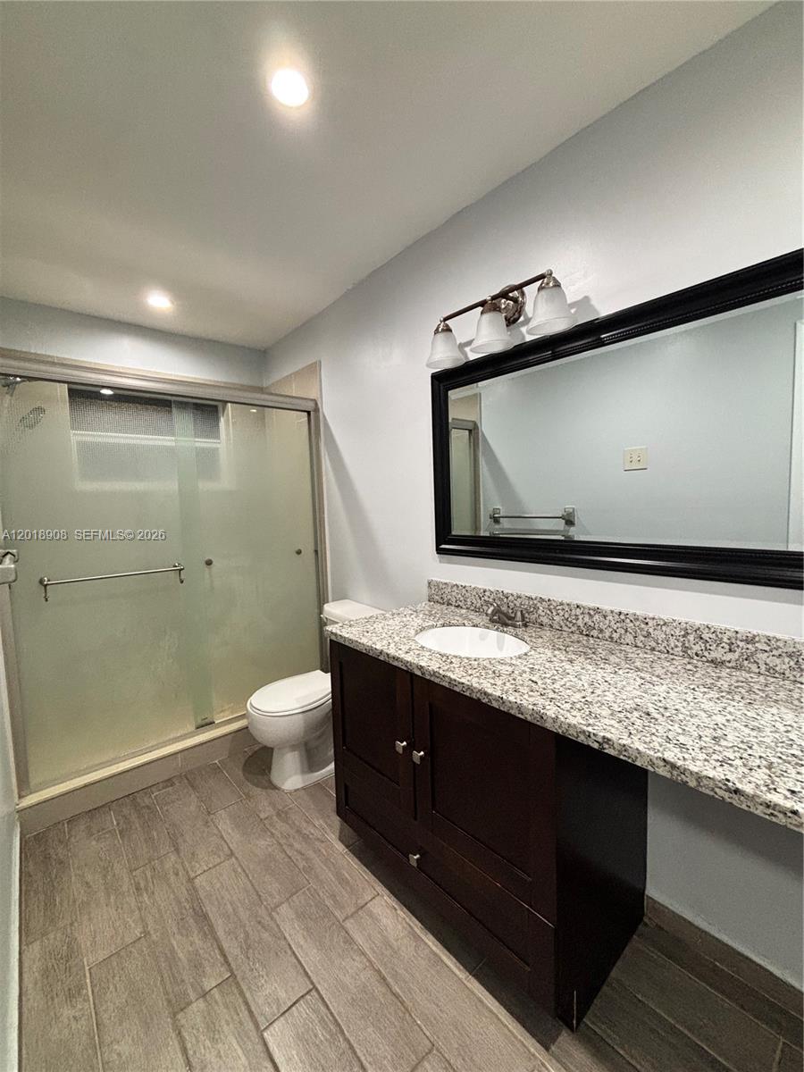 1480 East Sample Road, Unit 209 Pompano Beach, FL 33064 - Photo 16 of 24 a bathroom with a sink a toilet and shower
