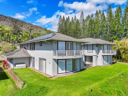 a view of a house with pool and a yard