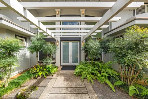 a view of a hallway with wooden floor and entryway