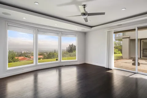 a spacious bedroom with a large bed and a large window