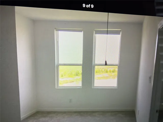 a bathroom with a window a ceiling fan and a wooden floor