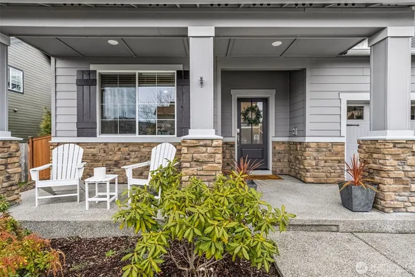 a front view of a house with outdoor seating