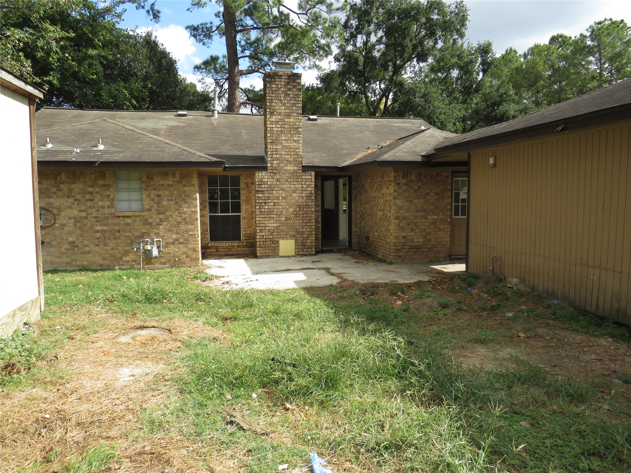 18703 Shay Lane Humble, TX 77346 - Photo 14 of 18 a view of a brick house with a large window and a large tree