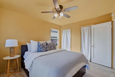 a bedroom with a bed and a lamp