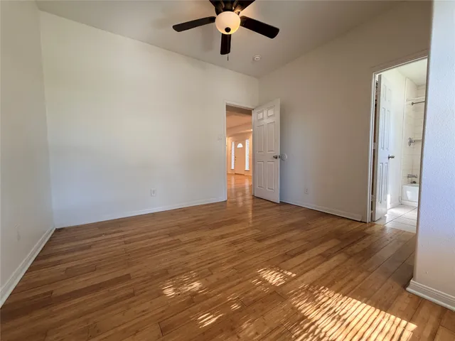 a view of an empty room and wooden floor