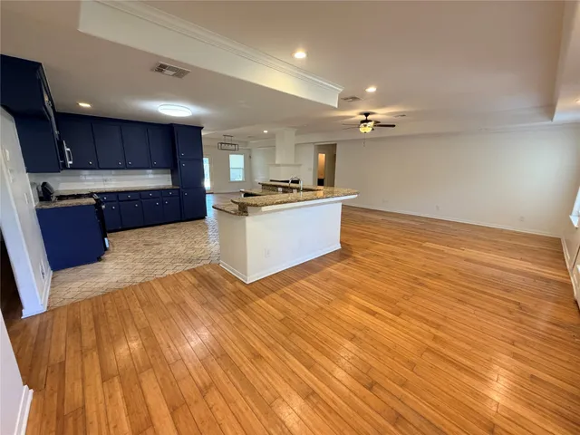 a large kitchen with stainless steel appliances granite countertop a dishwasher and a stove