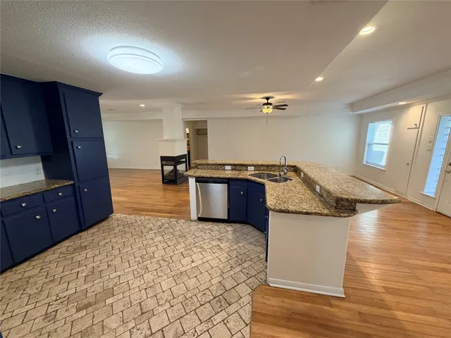 a kitchen with stainless steel appliances granite countertop a sink and stove