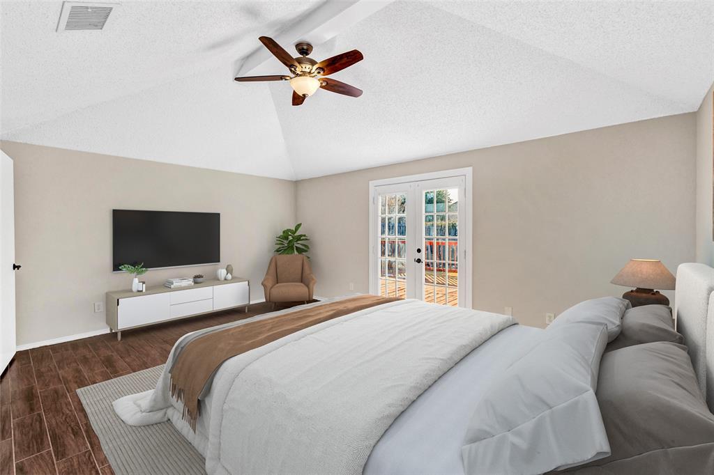 710 Cimarron Trail Irving, TX 75063 - Photo 13 of 39 a bedroom with a bed and a flat screen tv