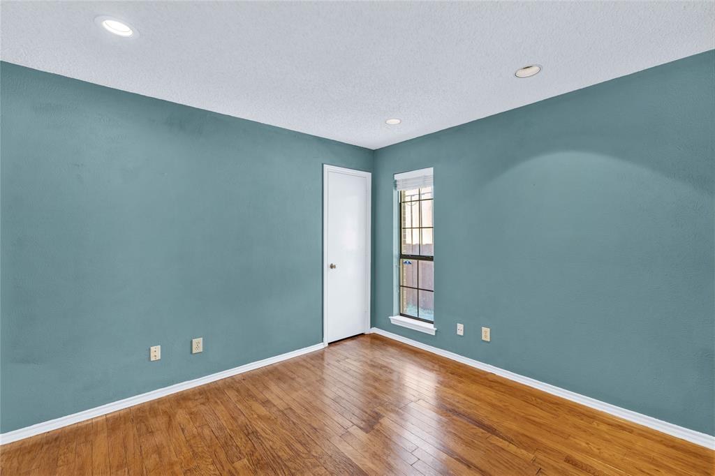 710 Cimarron Trail Irving, TX 75063 - Photo 21 of 39 a view of room with window and wooden floor