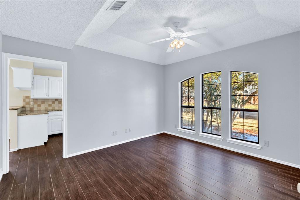 710 Cimarron Trail Irving, TX 75063 - Photo 26 of 39 wooden floor in an empty room with a window