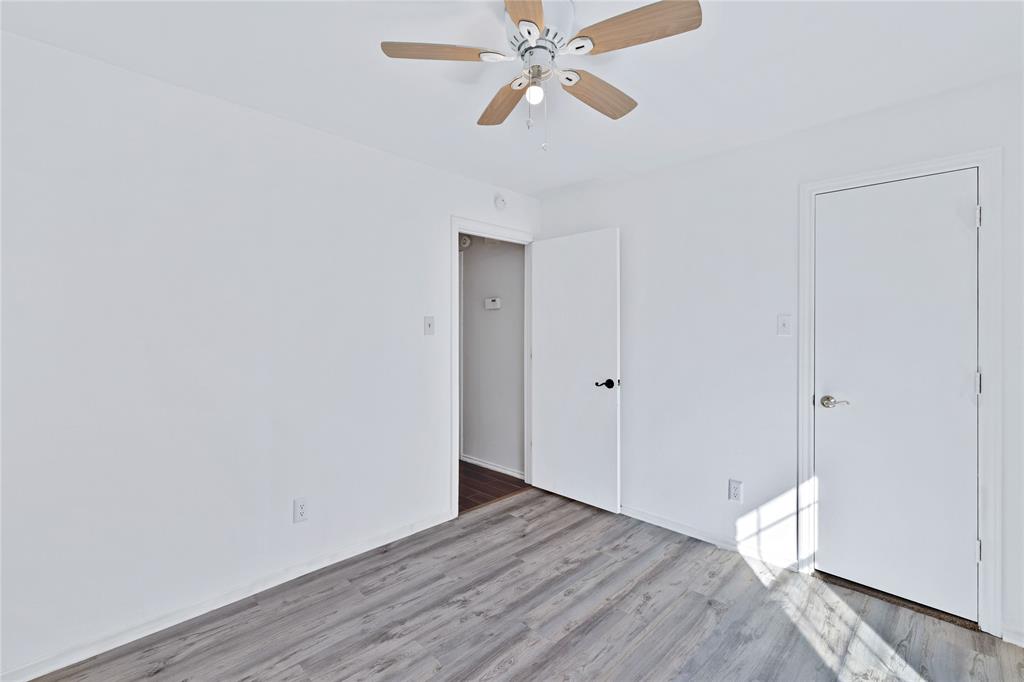 710 Cimarron Trail Irving, TX 75063 - Photo 32 of 39 a view of empty room with wooden floor