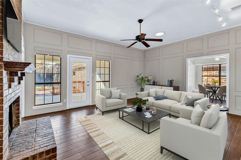 710 Cimarron Trail Irving, TX 75063 - Photo 5 of 39 a living room with furniture a fireplace and a flat screen tv