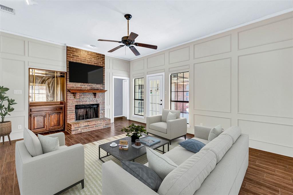 710 Cimarron Trail Irving, TX 75063 - Photo 7 of 39 a living room with furniture a flat screen tv and a fireplace