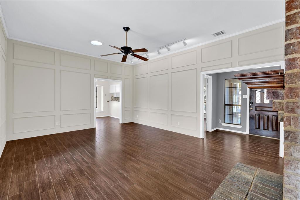 710 Cimarron Trail Irving, TX 75063 - Photo 8 of 39 a view of a livingroom with wooden floor ceiling fan and window