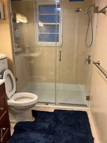 a bathroom with a toilet and a shower