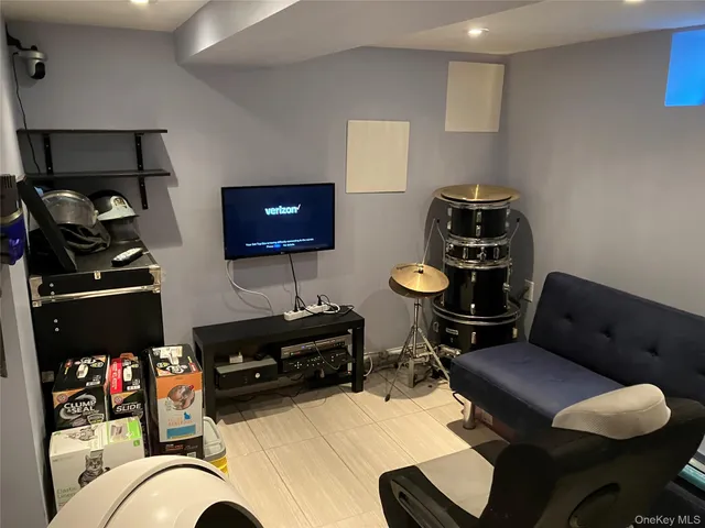 a living room with furniture cabinets and a flat screen tv