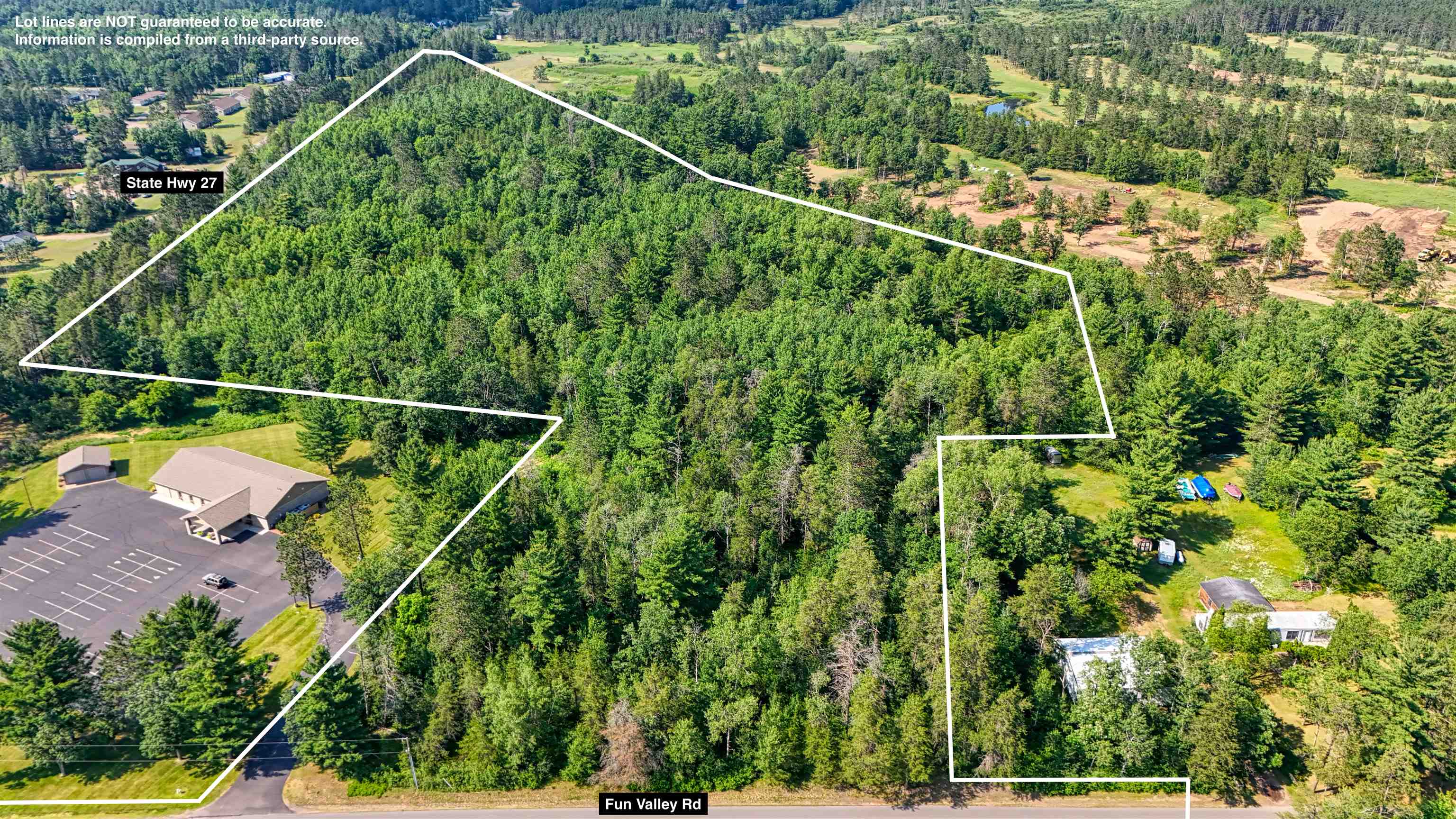 Aerial overview of property's location featuring a forest and property boundaries highlighted