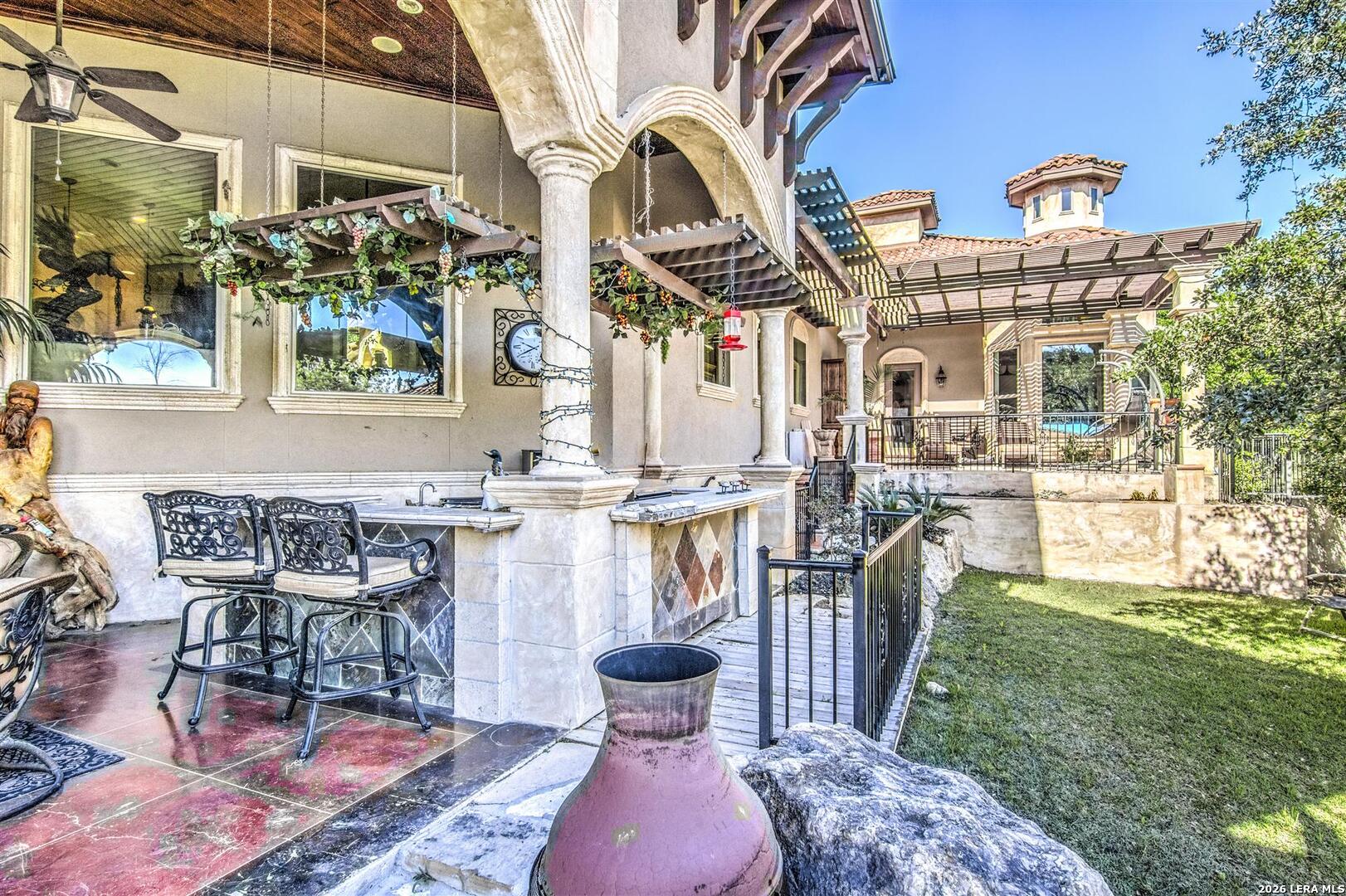 9469 Canyon Mist Helotes, TX 78023 - Photo 26 of 50 a view of a chairs and table in backyard
