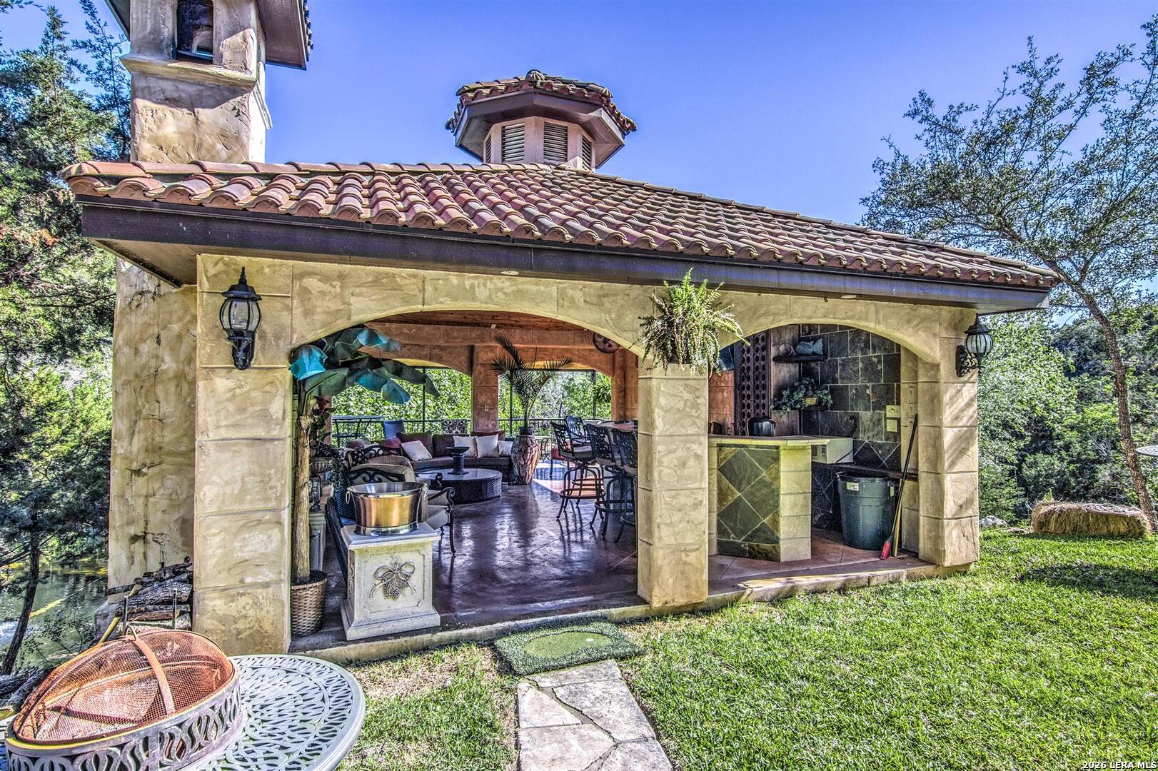 9469 Canyon Mist Helotes, TX 78023 - Photo 27 of 50 a view of a patio with a table and chairs