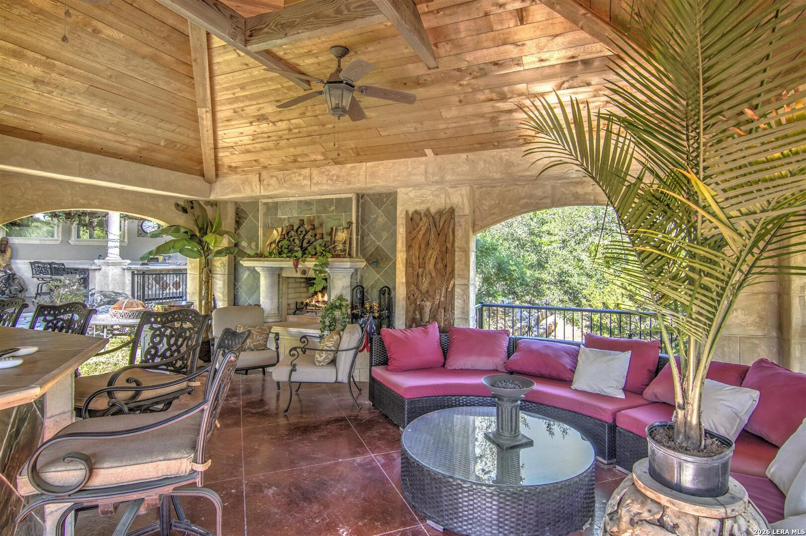 9469 Canyon Mist Helotes, TX 78023 - Photo 29 of 50 a view of a patio with couches table and chairs and potted plants