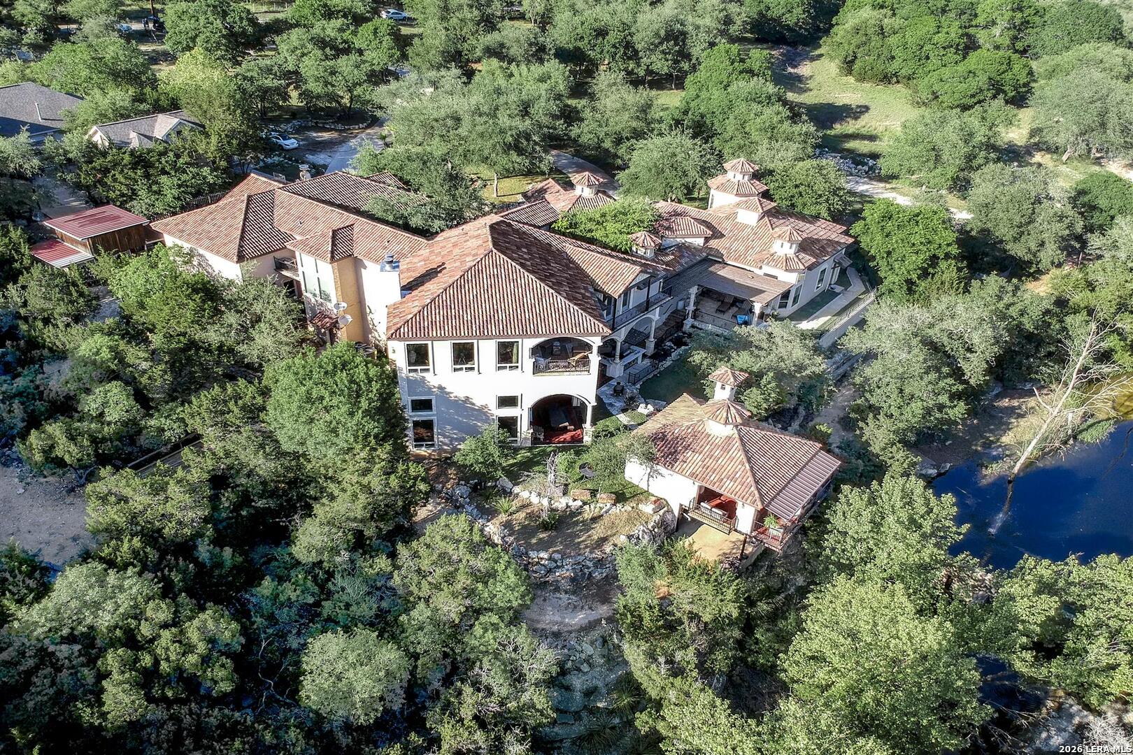 9469 Canyon Mist Helotes, TX 78023 - Photo 3 of 50 an aerial view of a house with a yard and outdoor seating