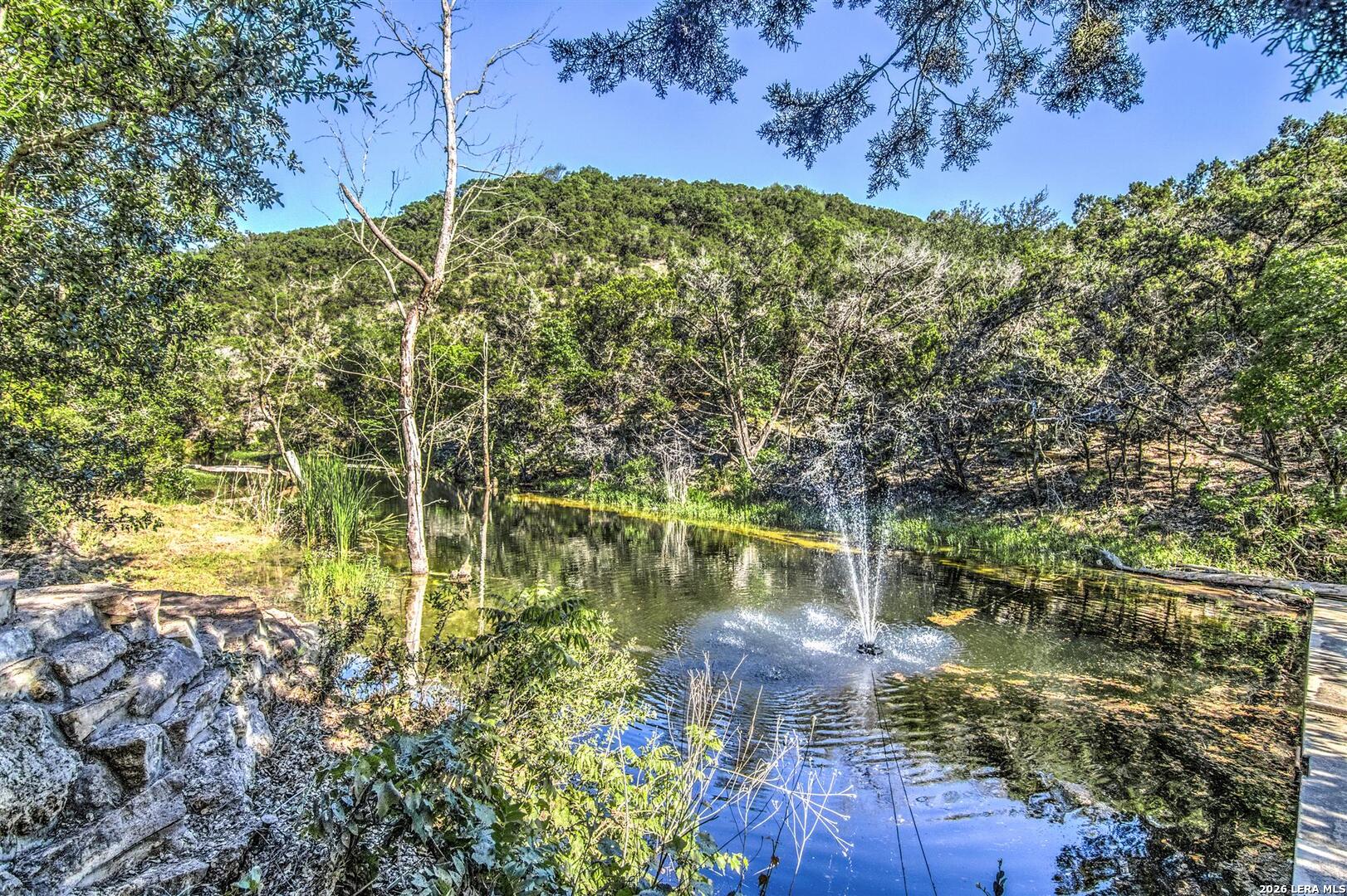 9469 Canyon Mist Helotes, TX 78023 - Photo 31 of 50 a view of a lake with a house in the background
