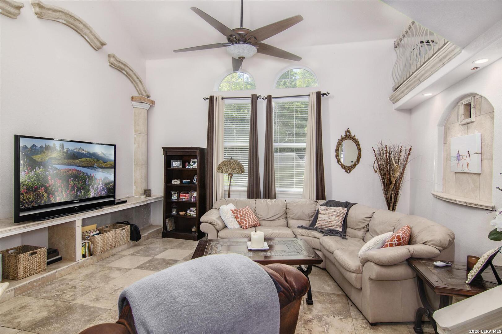 9469 Canyon Mist Helotes, TX 78023 - Photo 35 of 50 a living room with furniture a chandelier and a flat screen tv