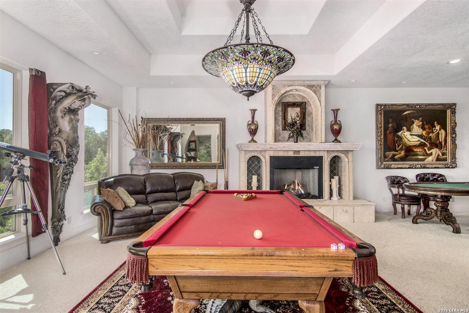 9469 Canyon Mist Helotes, TX 78023 - Photo 43 of 50 a living room with furniture a chandelier and a fireplace