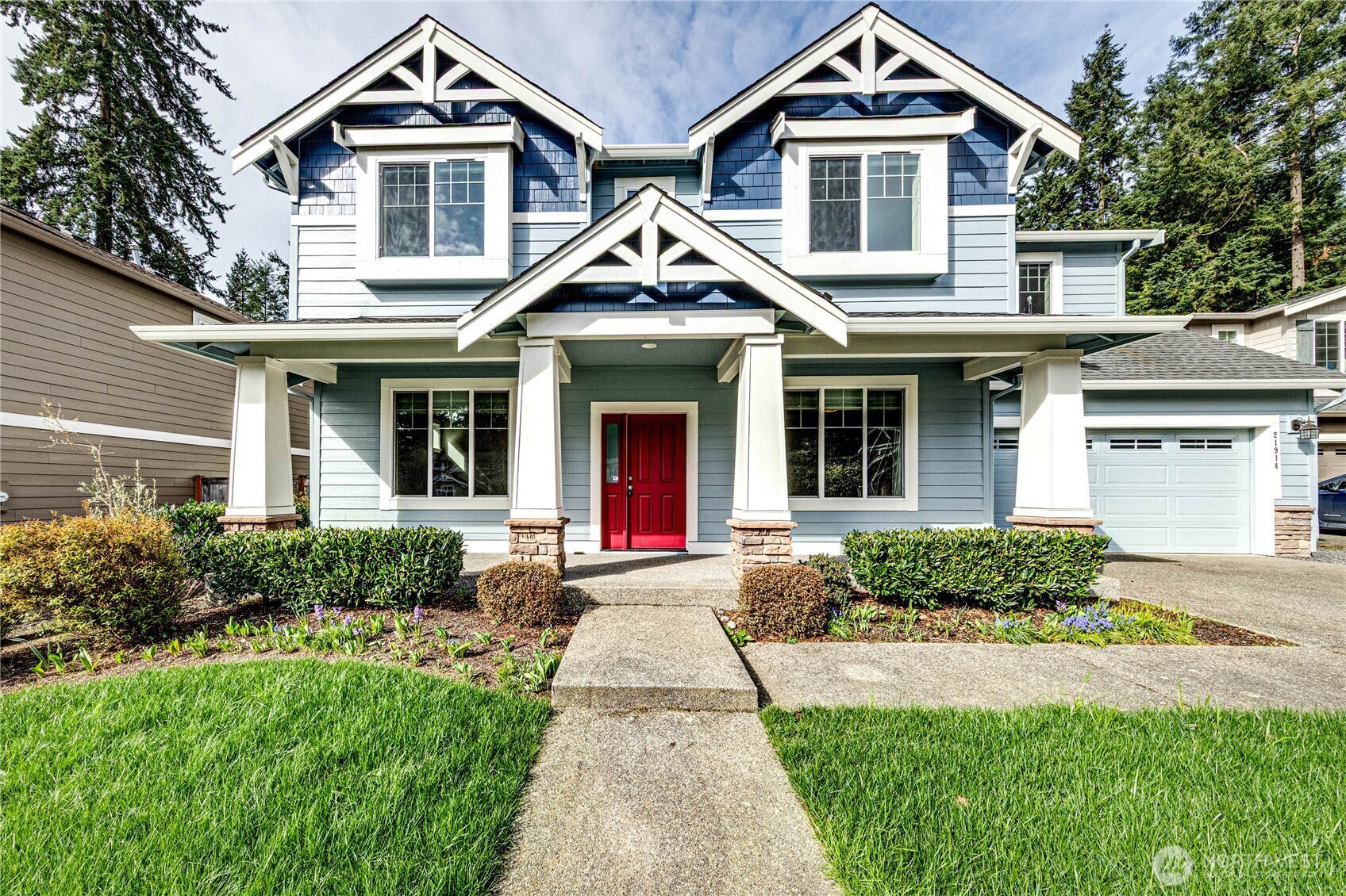 a front view of a house with yard and green space