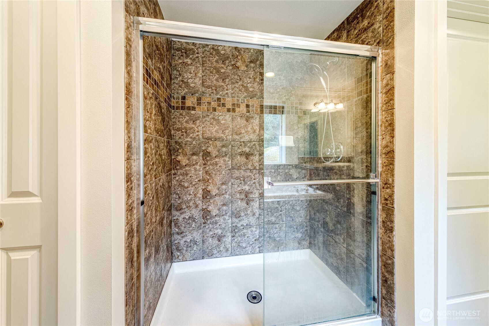 21914 78th Place West Edmonds, WA 98026 - Photo 17 of 39 a bathroom with a glass shower door