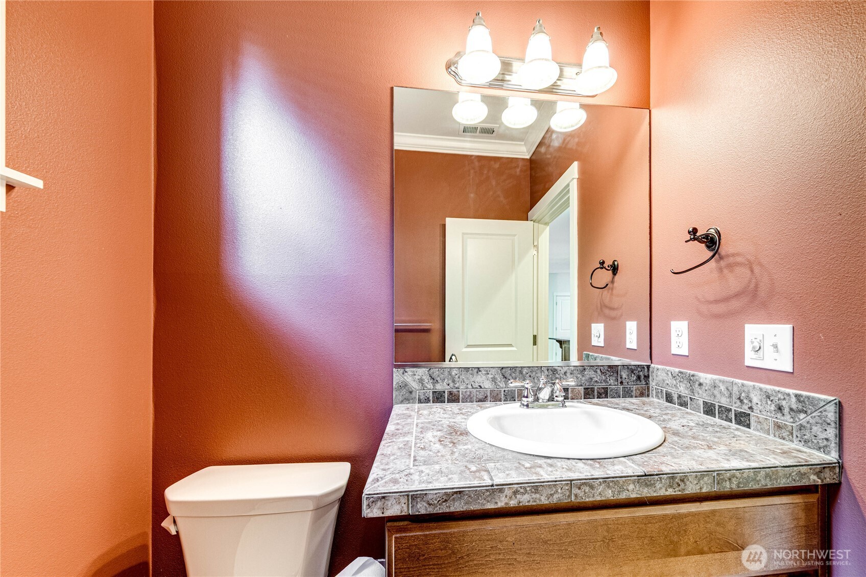 21914 78th Place West Edmonds, WA 98026 - Photo 24 of 39 a bathroom with a granite countertop sink and a mirror with toilet