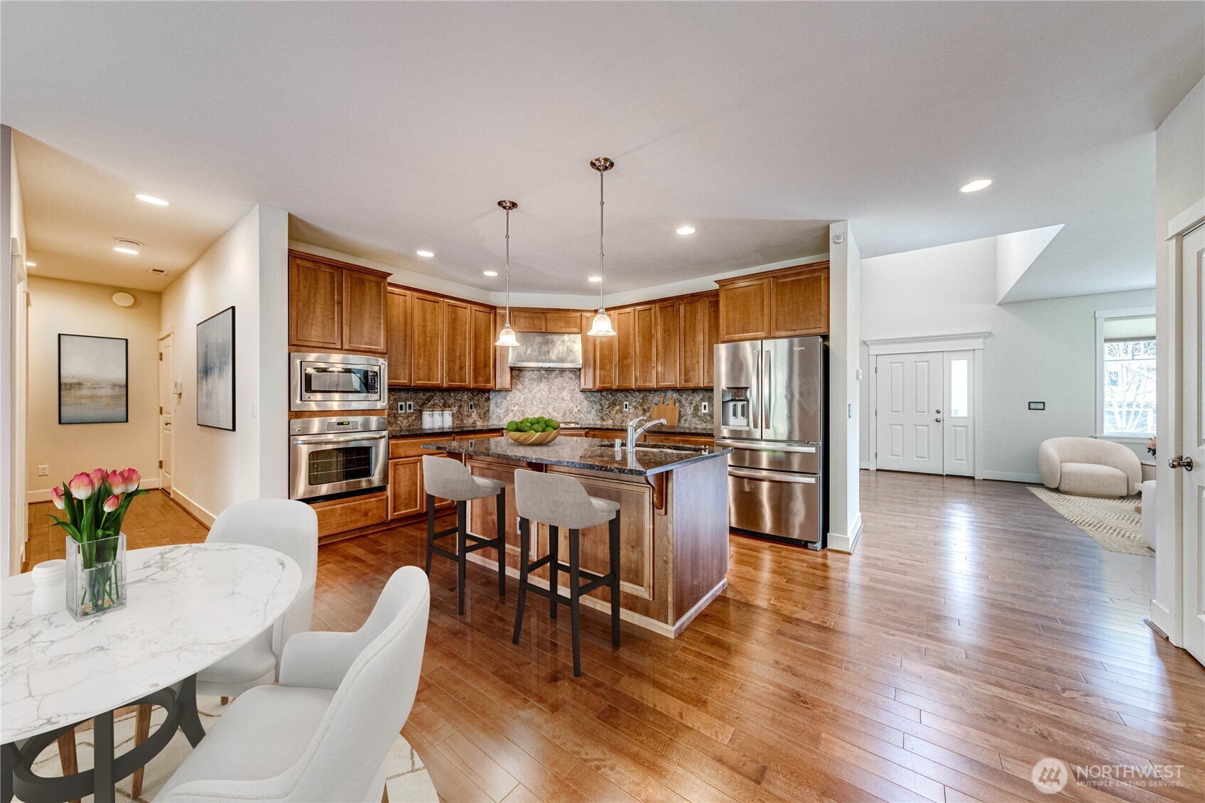 21914 78th Place West Edmonds, WA 98026 - Photo 9 of 39 a open kitchen view with stainless steel appliances refrigerator dining table and chairs