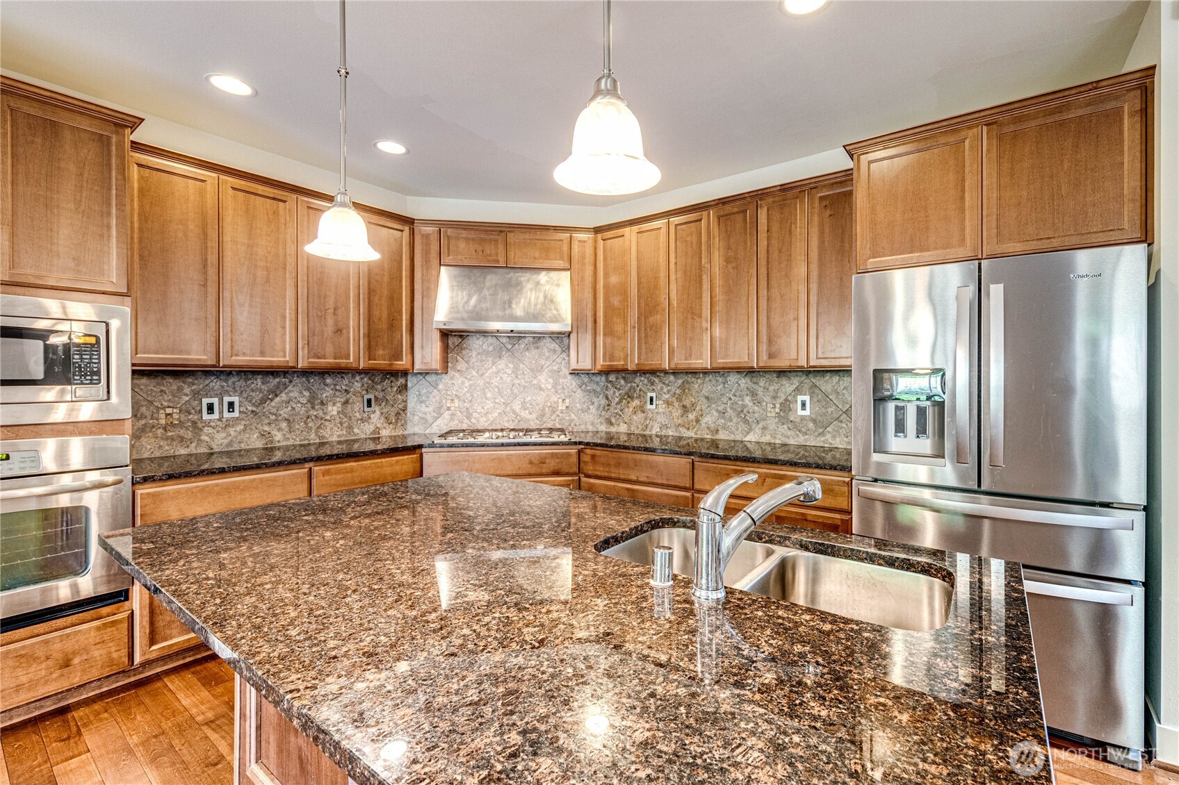 21914 78th Place West Edmonds, WA 98026 - Photo 10 of 39 a kitchen with stainless steel appliances granite countertop a refrigerator a stove top oven a sink and cabinets