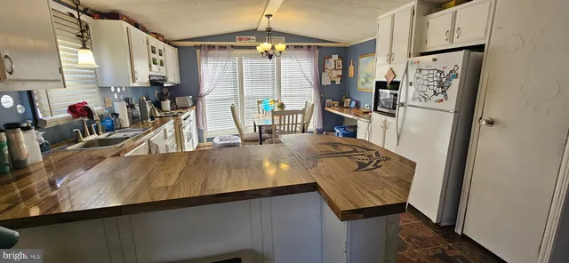 a view of a living room with furniture and a flat screen tv